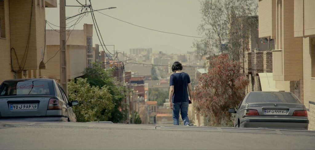 Hossein walking alone on street in Iran